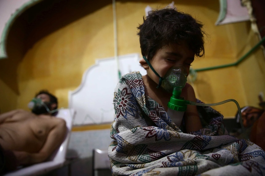 A child and a man are seen in hospital in the besieged town of Douma, Eastern Ghouta in Syria.