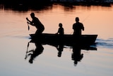 family fishing at sunset