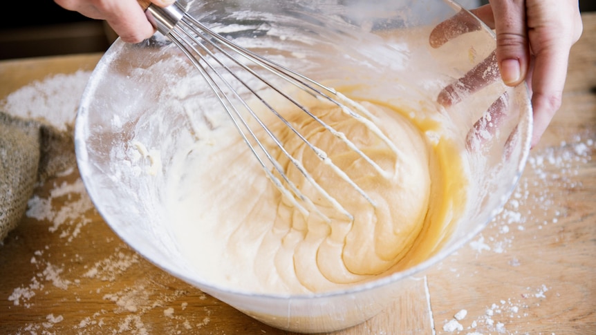 cake matter being whisked in a bowl