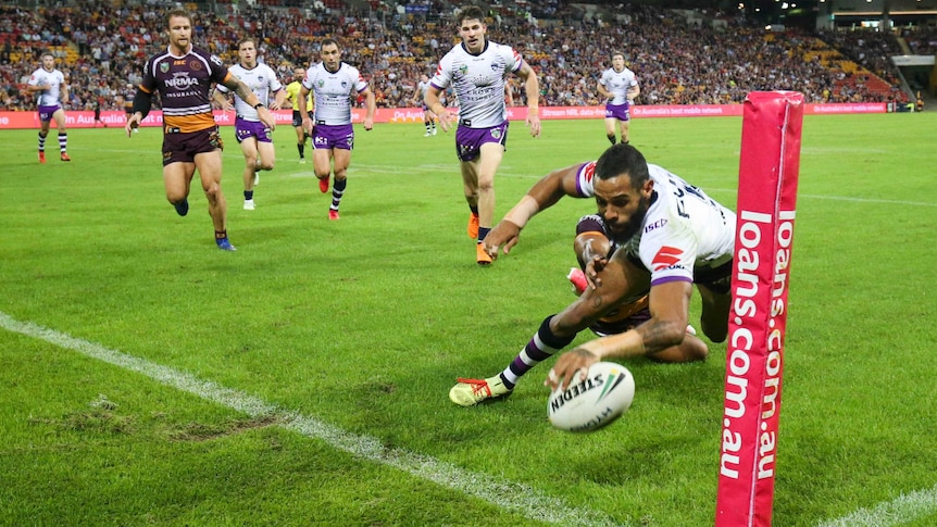 Joshua Addo-Carr of the Storm scores a try against the Brisbane Broncos at Lang Park.