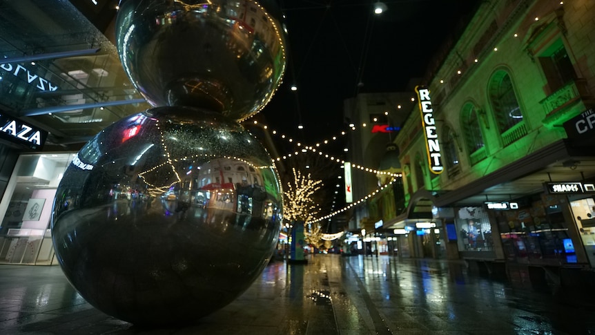 Two silver balls on top of each other in an empty pedestrian mall