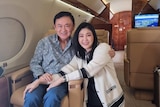 Thaksin Shinawatra with his sister Yingluck on a plane 