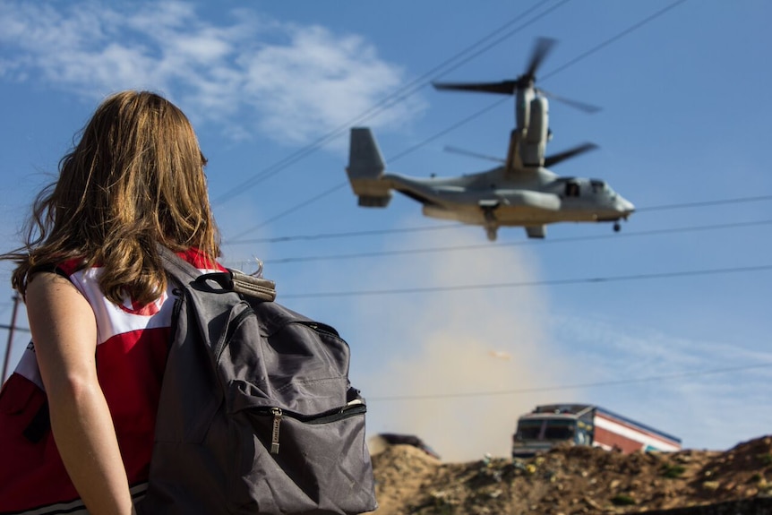 Caroline Anning watches US aid delivery in Nepal