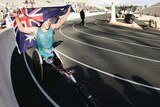 Kurt Fearnley pulls the Australian flag over his head after winning the T54 marathon in Athens.