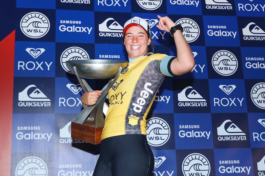 Tyler Wright holds the world surfing championship trophy