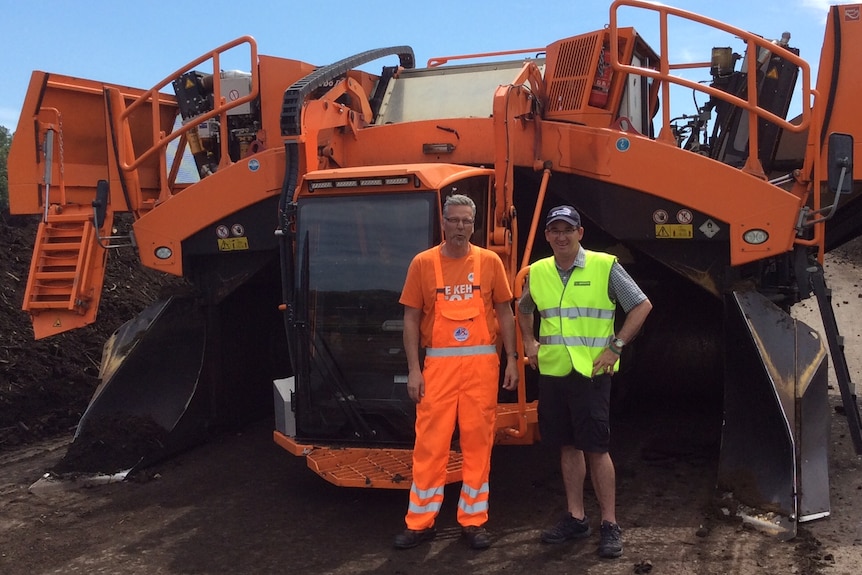 An employee from an Austrian compost facility with Churchill Fellow Jono Craven stand at a compost facility.