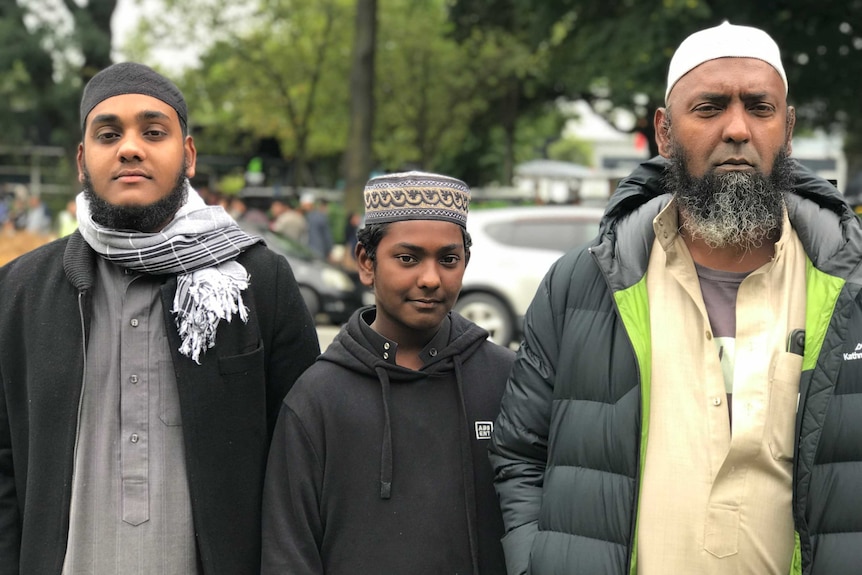 Three Muslim men looking serious on the streets of Christchurch.