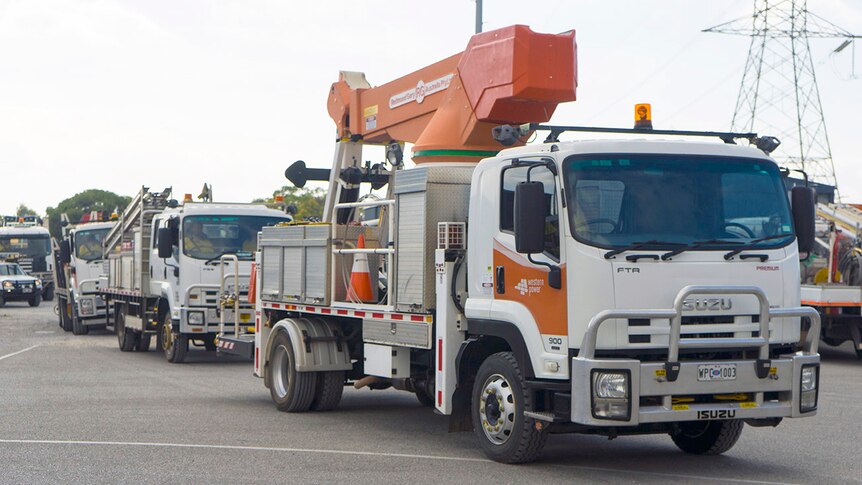 A convoy of Western Power trucks heading to the fire zone.