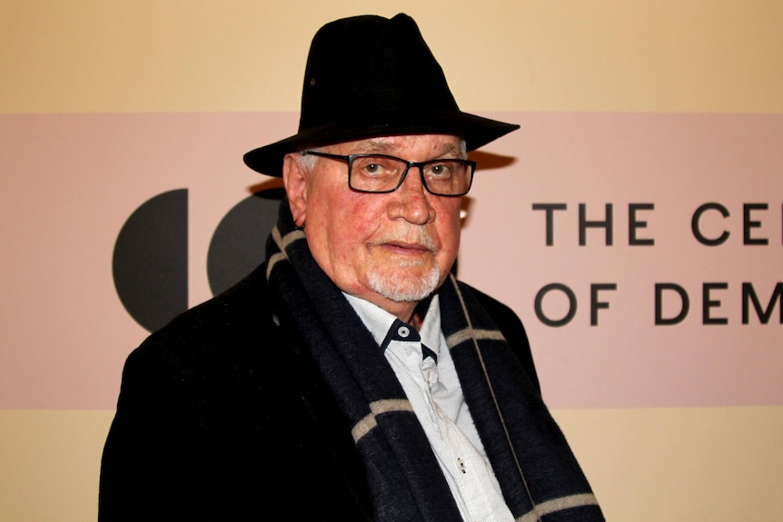 A man in a hat and glasses.