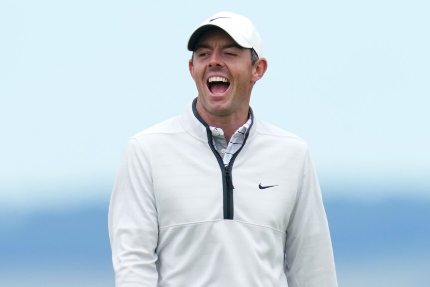 Rory McIlroy smiles on a golf course