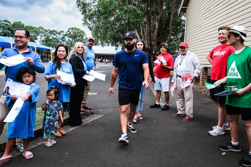 a man walking inside a public school to vote