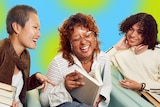 A stock image of a book club, with three people, two women and a young man, looking at a book and laughing