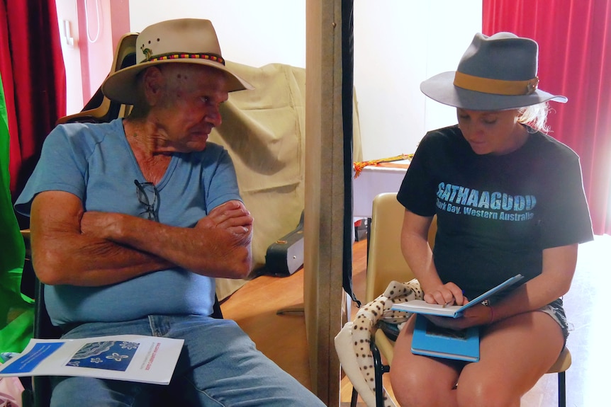 A medium shot of a man sitting on the left and a woman sitting on the right