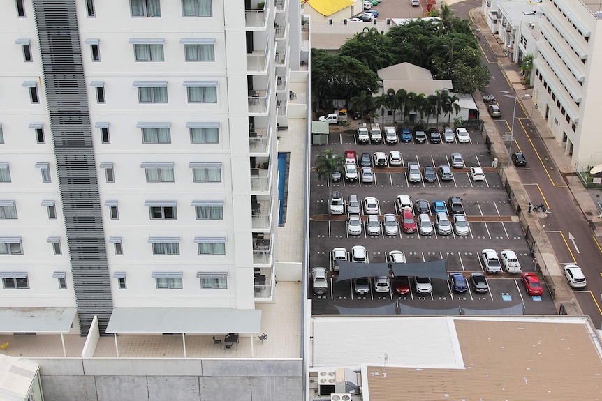 A high-angle view of a carpark and an apartment in Darwin's central business district.