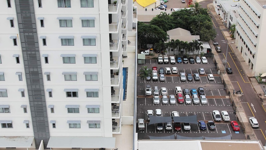 A high-angle view of a carpark and an apartment in Darwin's central business district.