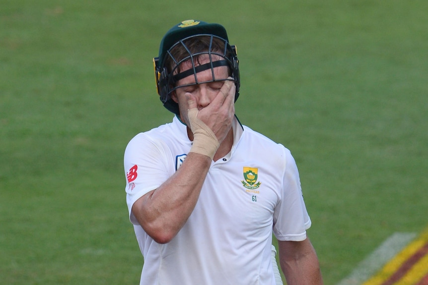 AB de Villiers holds his face