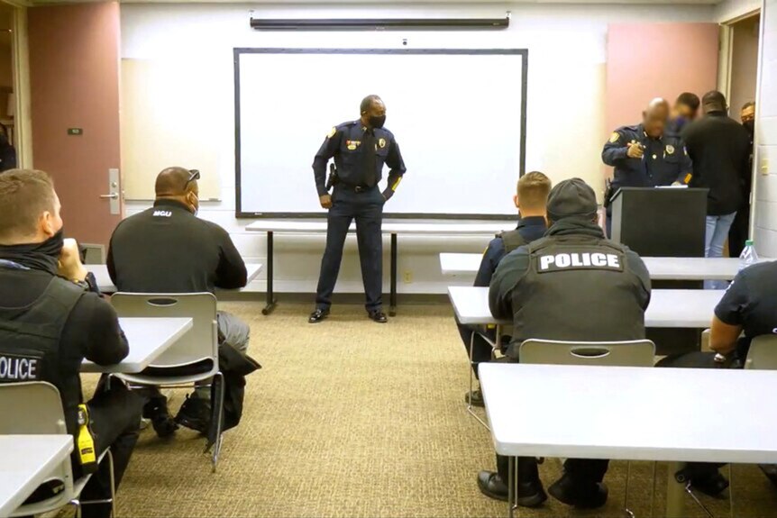 Police officers sitting at desks