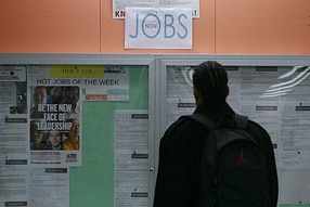 A man looks over employment opportunities at a jobs centre.