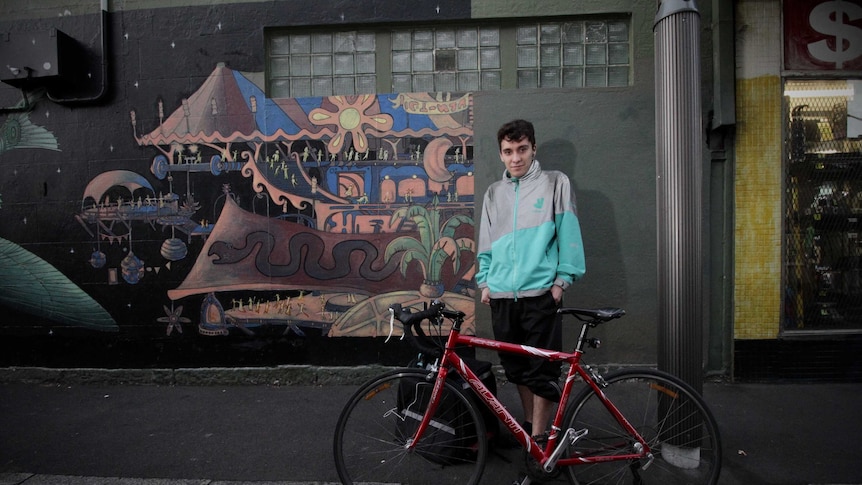 Deliveroo rider Anderson stands by his bike in Newtown, Sydney