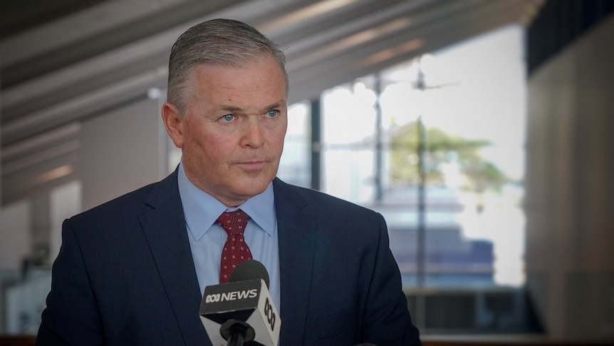 Kevin Gallagher pictured in a suit at a press conference