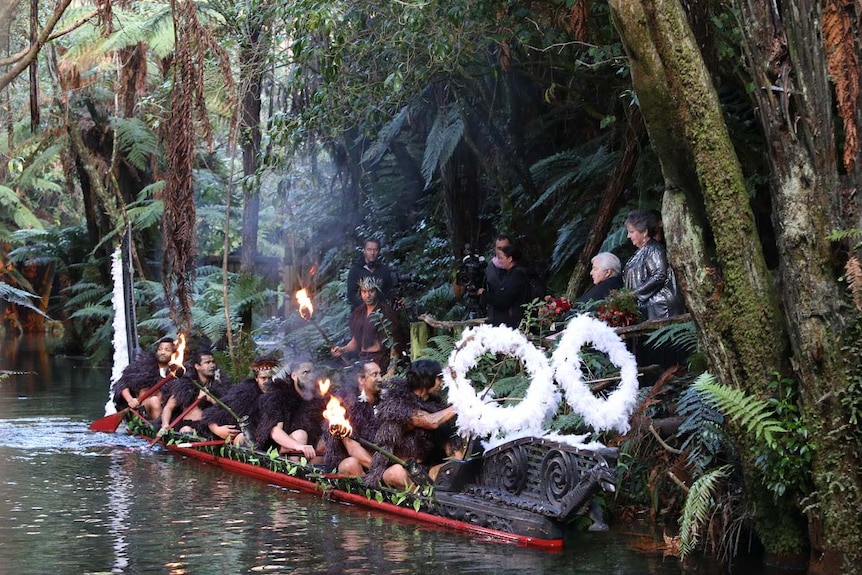 Gay Tasmanian couple (r) stand next to a Maori canoe before their wedding in New Zealand.
