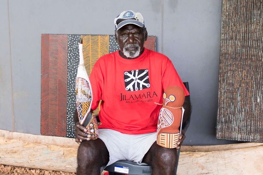 Pius Tipungwuti with the artwork he prepared for the Tiwi Islands 50th Grand Final celebrations and art sale.