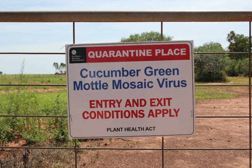 a quarantine sign on a gate