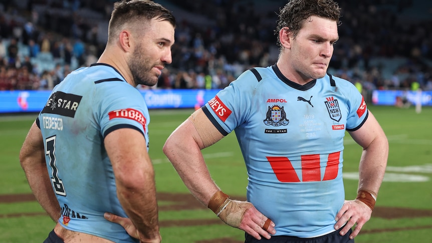 Two men look despondent after losing a State of Origin match