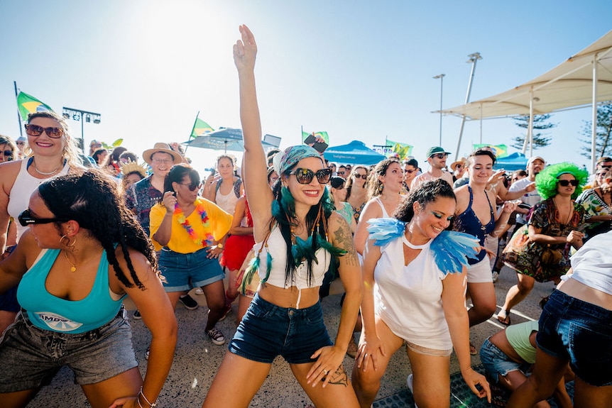 A crowed of people dancing.