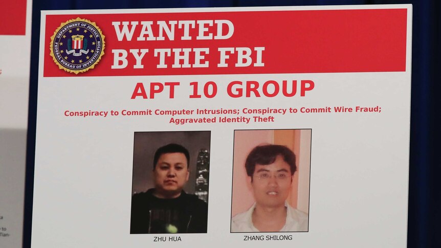 An electronic FBI wanted poster shows the faces of two Chinese men.