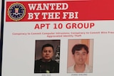 An electronic FBI wanted poster shows the faces of two Chinese men.
