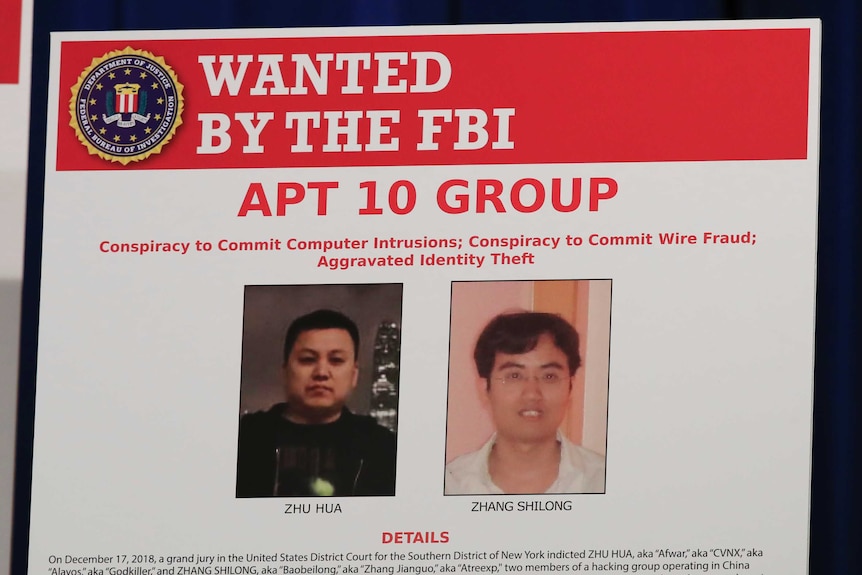 An electronic FBI wanted poster shows the faces of two Chinese men.