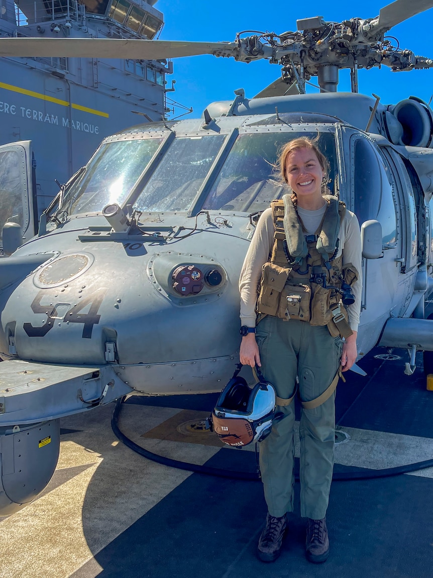 Julie Zezeski front of a helicopter.