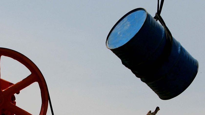 A Chinese laborer repairs an oil pumping unit at Huabei oil field on the outskirts of Hejian city