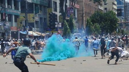 Islamist protesters run as Bangladeshi police fire rubber bullets towards demonstrators in the capital Dhaka.