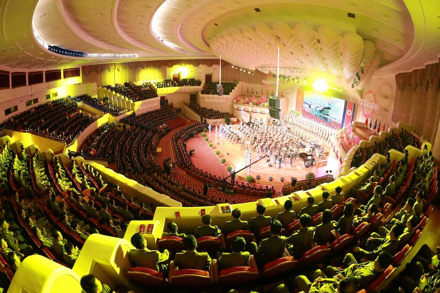 A celebration for nuclear scientists and engineers in Pyongyang. The concert hall appears to be full of people in formal attire.