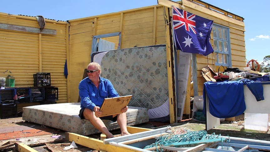 Robert Holness surveys the damage after his house in Marmor