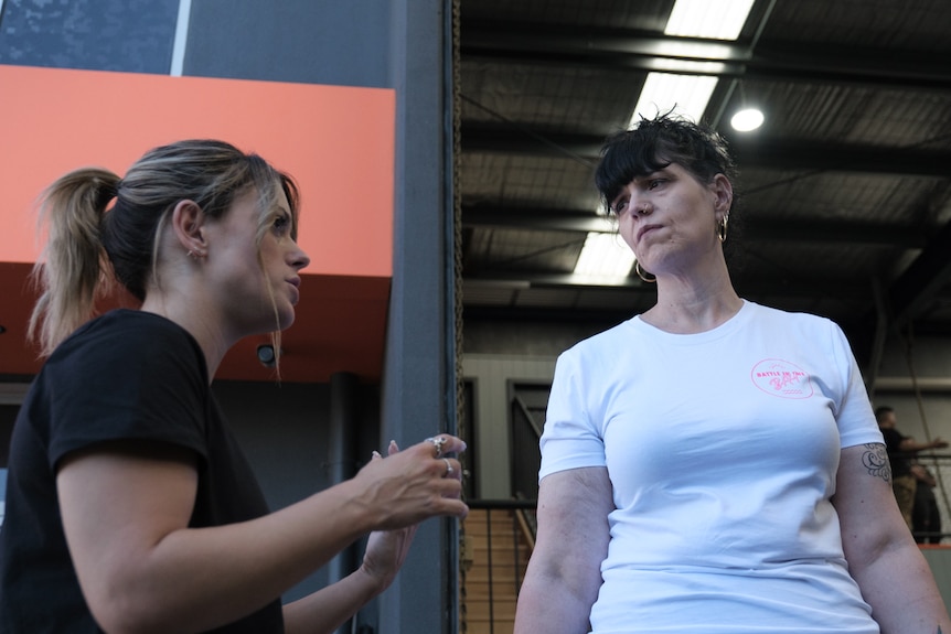 Nicole Brown speaks with Justine Martin outside a gym.