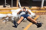 A man laying on the ground covered in ice