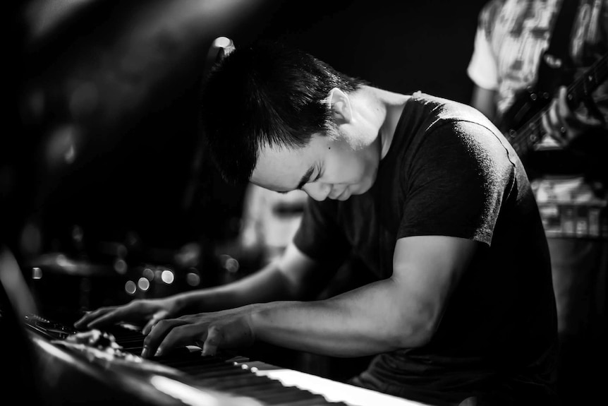 Keyboardist plays passionately.