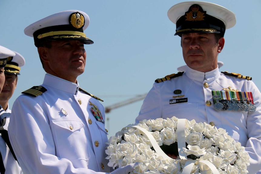 Captain Tokihiko Umezaki and Commander Karl Brinkmann lay a wreath at the commemoration service for Japanese submarine I-124.