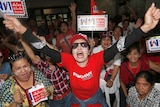 Supporters of Pheu Thai party cheer the televised Thailand election results.