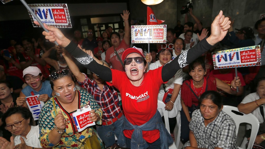 Supporters of Pheu Thai party cheer the televised Thailand election results.