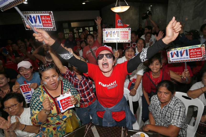 Supporters of Pheu Thai party cheer the televised Thailand election results.