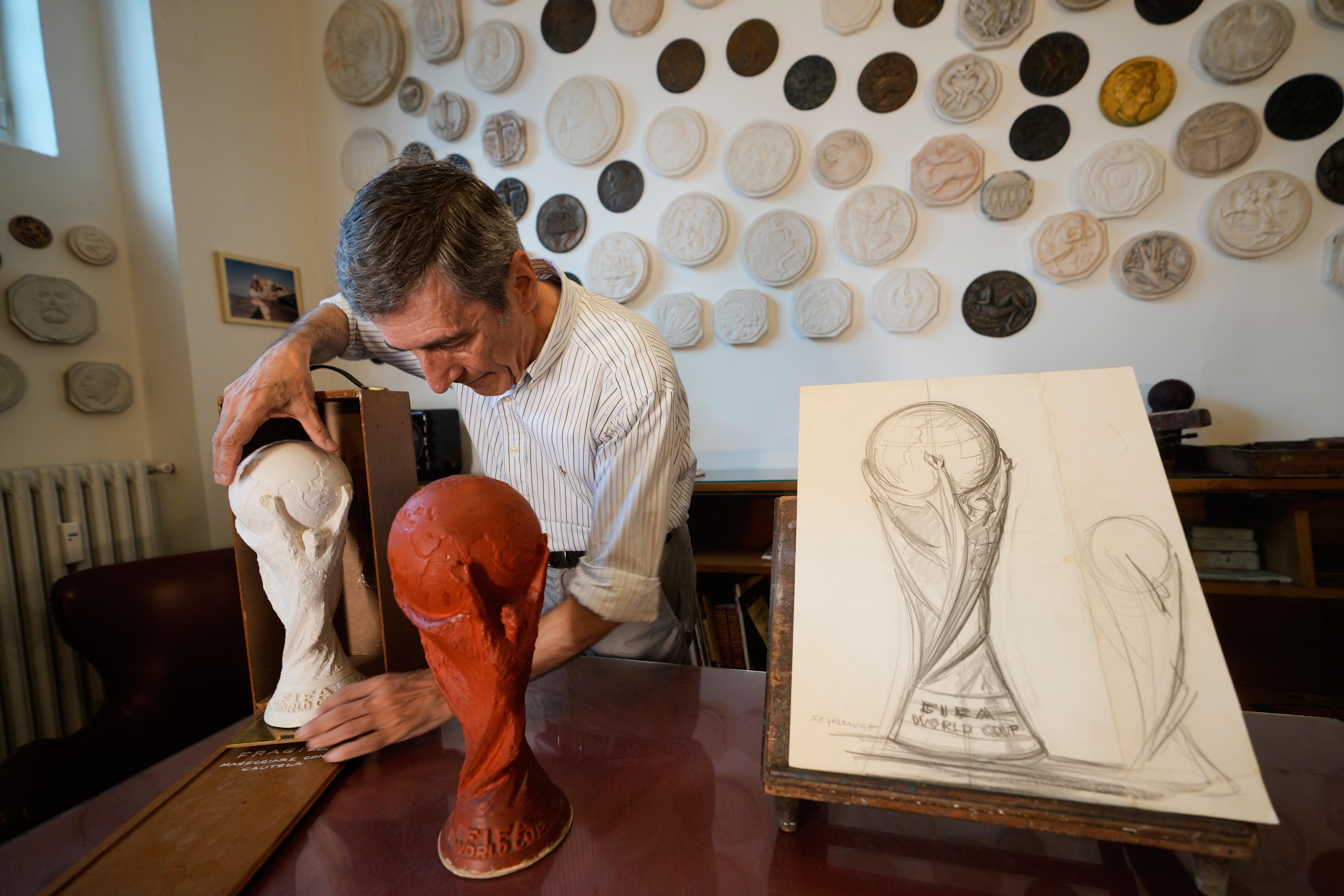 A man places a trophy into a box