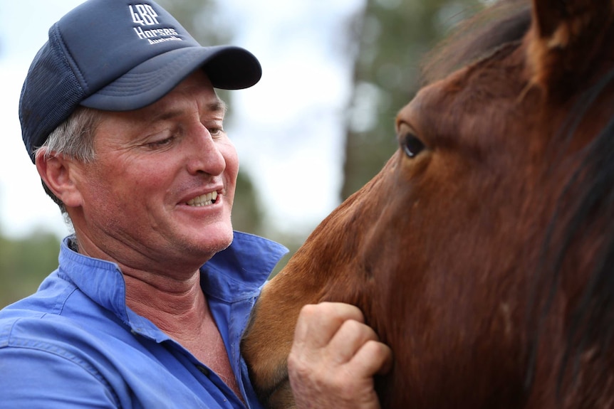 John Hughes and a brumby he has been training