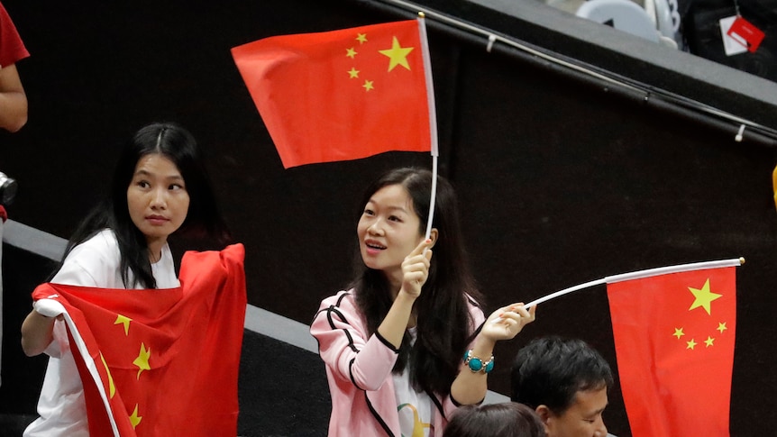 Fans wave Chinese flags at Rio 2016 Olympics