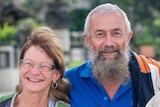 John and Ellen Gotts smile at the camera. The couple is well dressed and photographed outside.