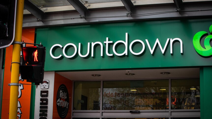 A front facade of a Countdown store has green Woolworths-like branding. 