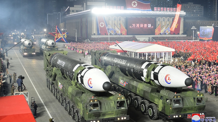 Missiles are driven on top of military vehicles at a parade in North Korea